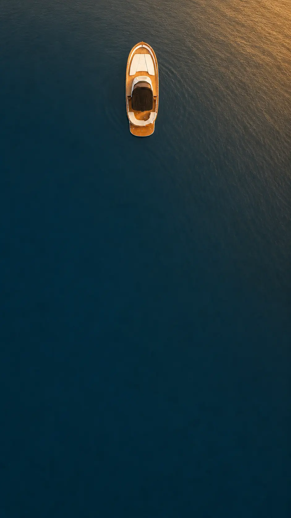 The Libeccio 8.5 from above at golden hour, open water around it